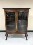 An early 20th century glazed door bookcase
