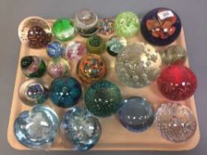 A tray of twenty-three assorted glass paperweights