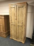 A pine double door pantry cupboard