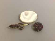 Three antique brooches - two garnet and one agate in gold settings.