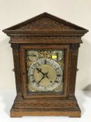 An oak cased quarter-striking table clock,