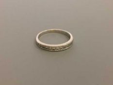 An 18ct gold diamond half eternity ring