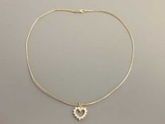 An 18ct gold diamond set heart pendant on chain, the total diamond weight approximately 1.