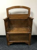 An oak storage hall seat