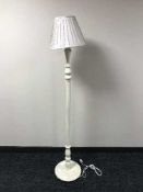 A cream column standard lamp and shade