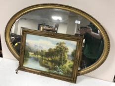An oval gilt framed mirror,