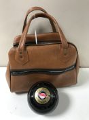 Four bowling balls by Thomas Taylor of Glasgow, contained within a brown carry bag.