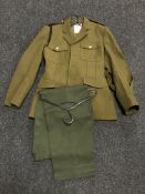 A part rail of eleven army dress jackets and six pairs of trousers