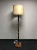 An early 20th century oak standard lamp