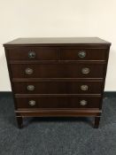 A mid 20th century five drawer mahogany chest