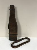 A leather leg o' mutton shotgun case and a cartridge belt