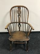 An antique elm Windsor style armchair