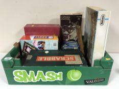 A box of assorted board games and jigsaws