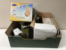 A box containing a Professional steam iron, Scholl handcare kit, cameras,