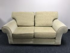 A two seater settee and armchair in sand coloured fabric