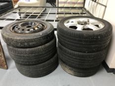 Four Ford Cougar alloy wheels with tyres and two further wheels with tyres