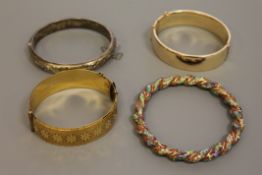 A quantity of silver and gold plated bangles