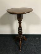 An antique mahogany pedestal wine table with walnut top