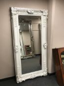 A large cream bevelled overmantel mirror