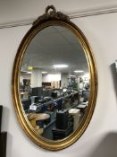 A decorative oval framed mirror