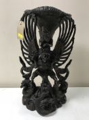 A heavily carved eastern deity