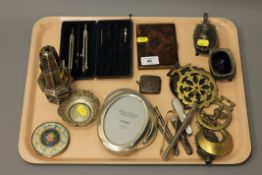 A tray containing plated wares, horse brasses, silver vesta, writing utencils,