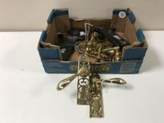 A box containing brass door handles and door locks with keys