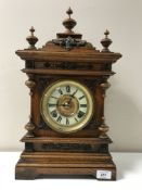 An oak cased American mantel clock by the Ansonia Clock Company,