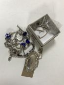 A silver whisky label, silver bracelet and chain etc.