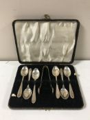 Six silver teaspoons and a silver plated sugar tong, cased.