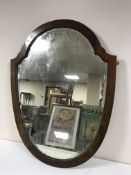 A large mahogany framed shield mirror and an oval mirror
