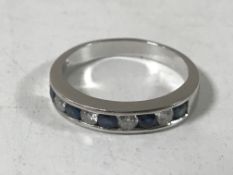 An 18ct white gold diamond and sapphire half eternity ring, size Q.