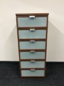 A contemporary glass fronted six drawer chest