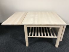 A stripped pine flap sided coffee table