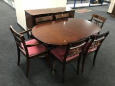 An eight piece inlaid mahogany Regency style dining room suite