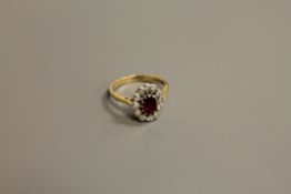 An 18ct gold ruby and diamond cluster ring, size N-O, 4.1g.