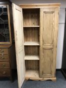 A pine two door pantry cupboard