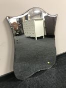 A shield shaped bevelled edge mirror