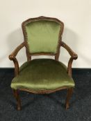 A carved framed armchair upholstered in dralon