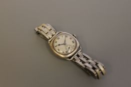 A vintage silver Zenith wristwatch on a flexible silver strap