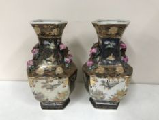 A pair of 20th century oriental vases embossed with pink flowers