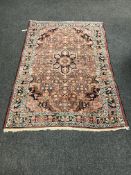 A Persian Hamadan rug on red ground