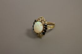 A sapphire and diamond ring set with a large opal