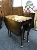 An oak gate leg table and a mahogany commode chair