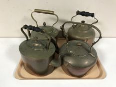A tray of four antique copper kettles