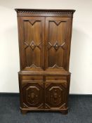 A reproduction walnut double door corner cabinet