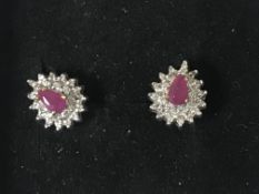 A pair of 9ct gold ruby and diamond cluster earrings.