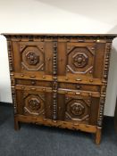 An ornate walnut four door sideboard