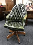 A green button Chesterfield swivel office armchair