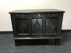 A 17th century style heavily carved oak blanket chest